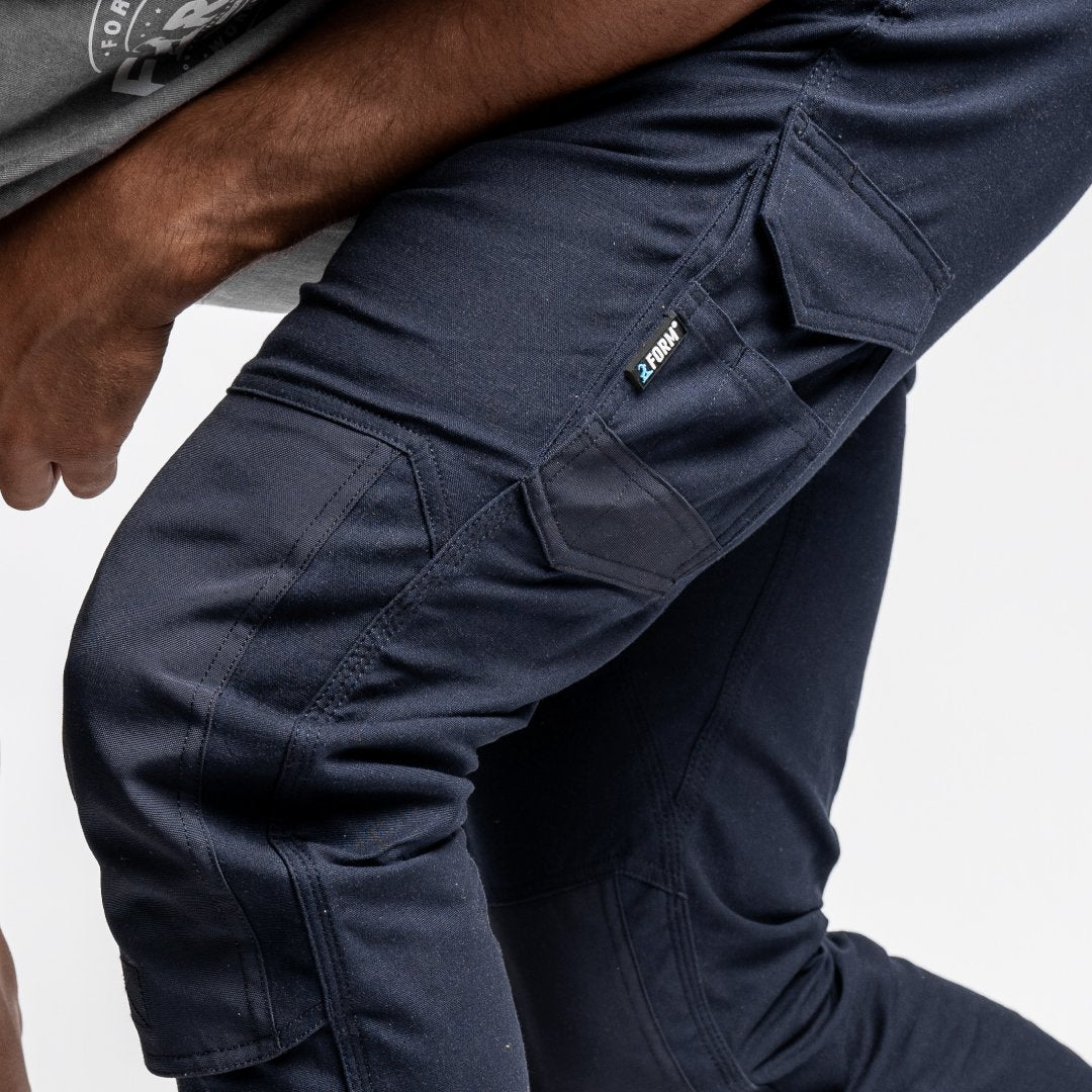 Detailed view of reinforced knee panels on Form Workwear FB1 navy work pants, designed for durability and flexibility