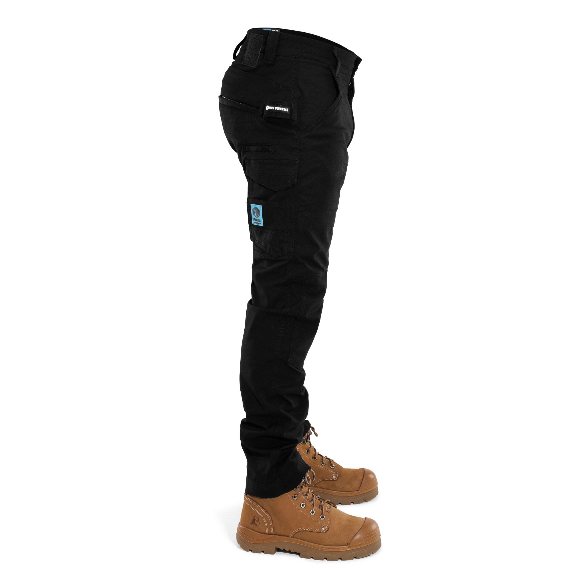 Side view of FB2 black work pants with tool pockets and Form Workwear logo patch