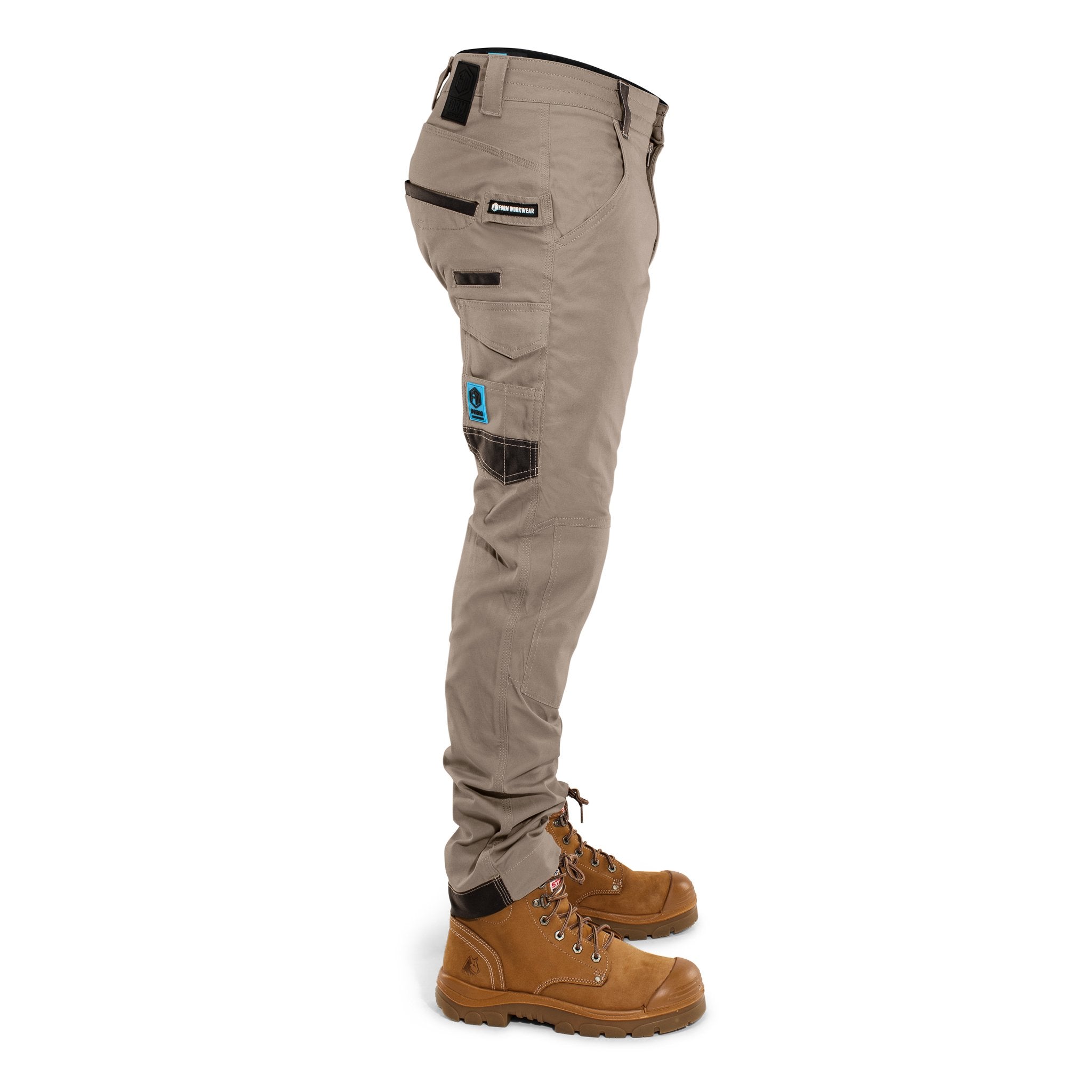 Side view of FB2 khaki stretch work pants featuring utility pockets and Form Workwear patch