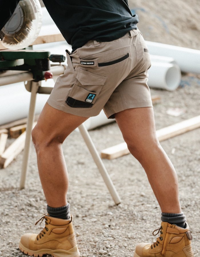 builder wearing blunstone boots for work and most durable work shorts for carpenters