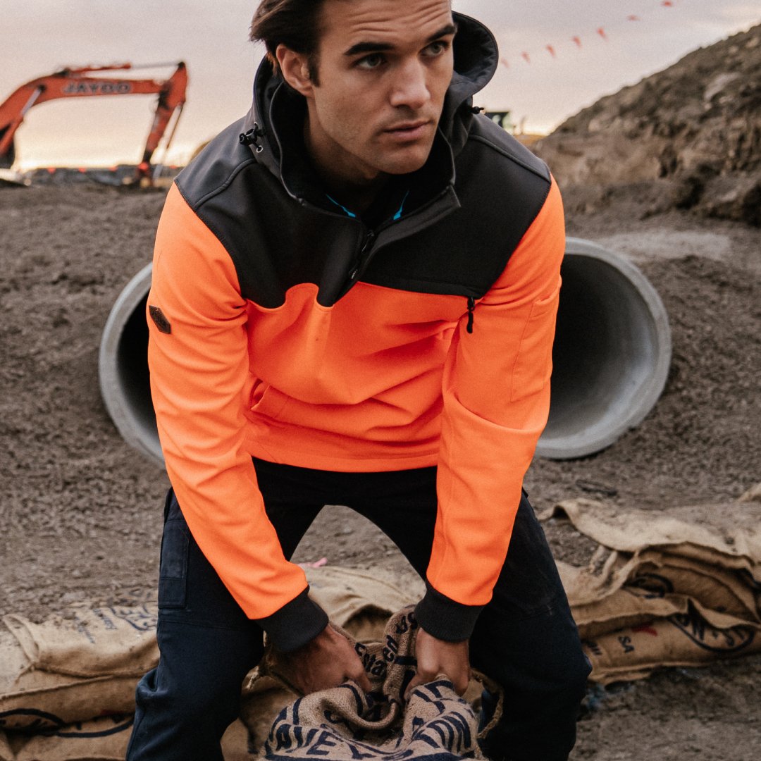 Tradesman wearing Form Workwear hi-vis jacket while working on a construction site