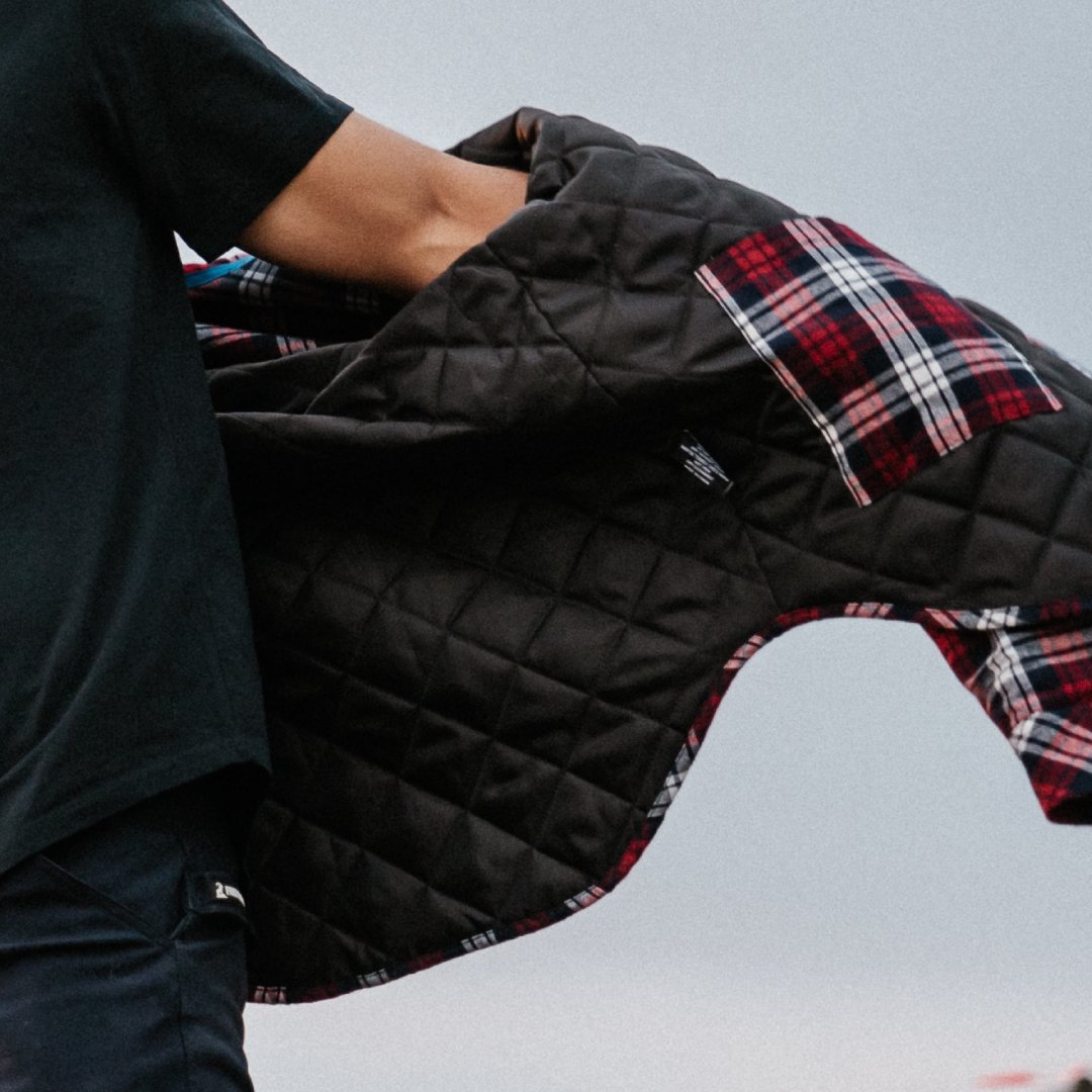 Interior of a work shirt featuring quilted lining for extra warmth, displayed during motion for outdoor work