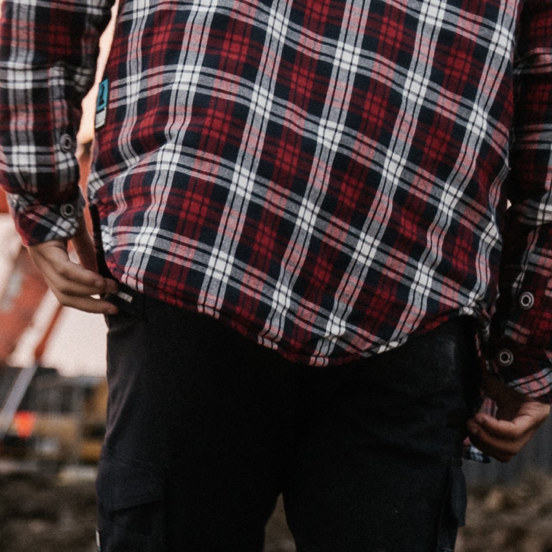 Rear tail detail of a plaid work shirt showing stitching and design tailored for comfort during movement