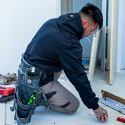 T4 DEXR work hoodie in black, on model at worksite