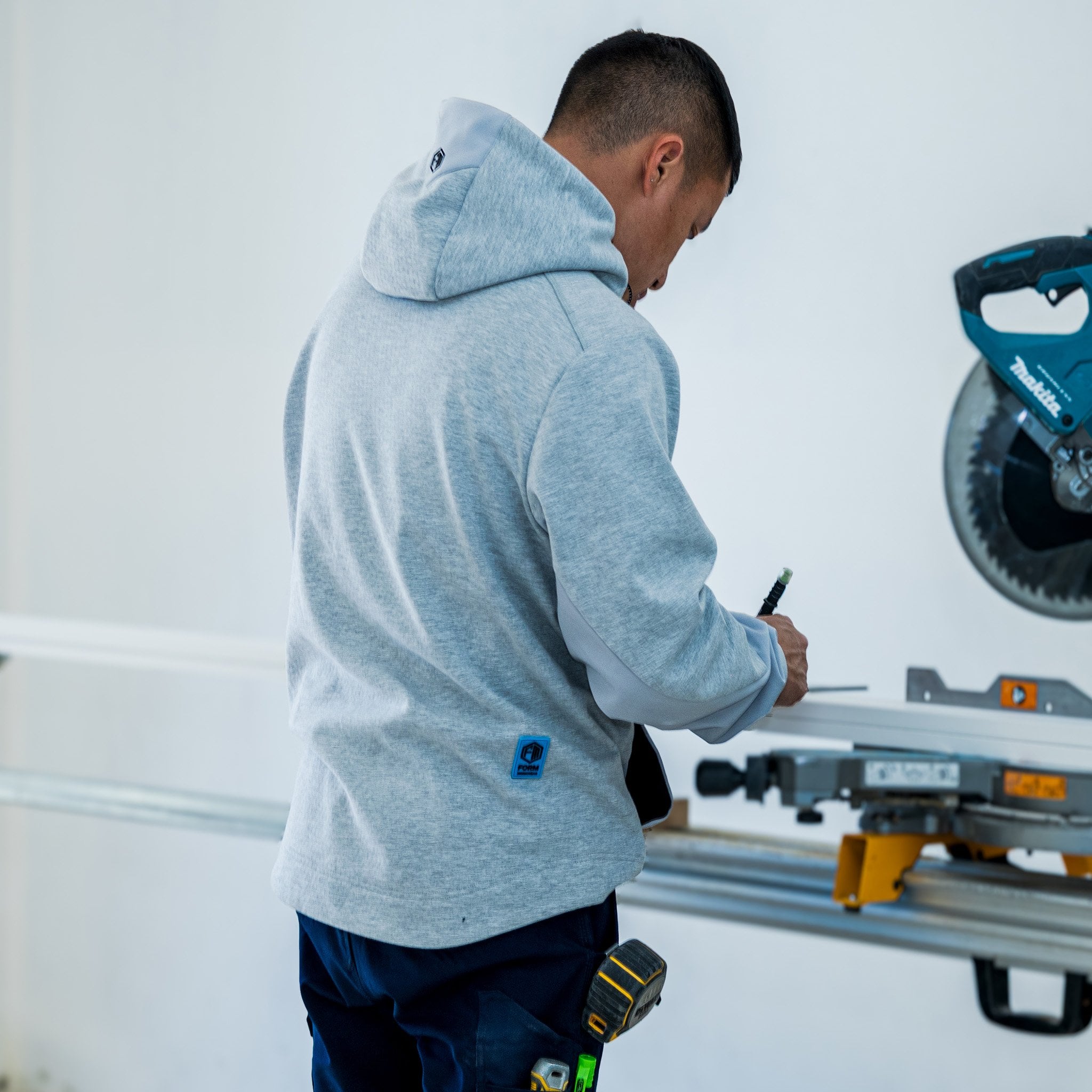 T4 DEXR work hoodie in grey, on model at worksite