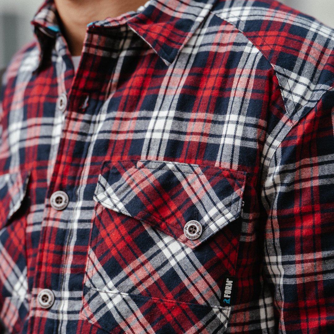 Close-up of utility pocket on workwear pants showing reinforced stitching and durable design for tradesmen